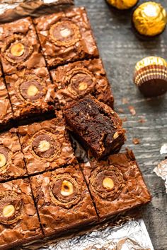 chocolate brownies cut into squares on top of tin foil