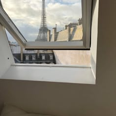 an open window with the eiffel tower in the background