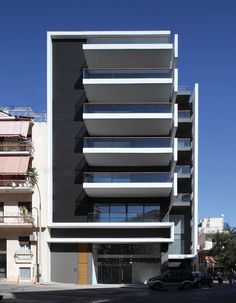 an apartment building with multiple balconies on the top and bottom floors in front