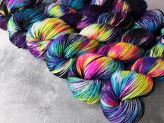 several skeins of multicolored yarn sitting on top of each other