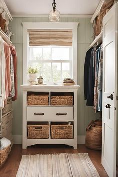 a closet with drawers, baskets and clothes hanging on the wall next to a window