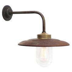 an old fashioned wall light with a bulb on it