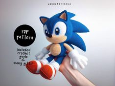 a crocheted sonic the hedge doll is being held by someone's hand