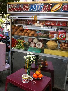 a food stand with fruits and vegetables on it