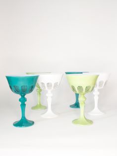 three glass goblets sitting next to each other