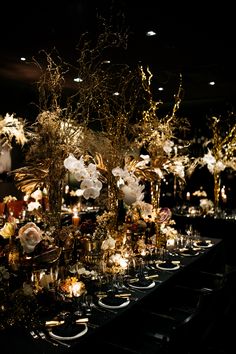 a long table is set with flowers and candles for an elegant dinnereonal event