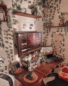 a desk with a computer monitor, keyboard and mouse on it in front of ivy covered walls