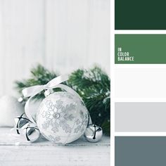 a christmas ornament sitting on top of a table next to evergreens and pine cones