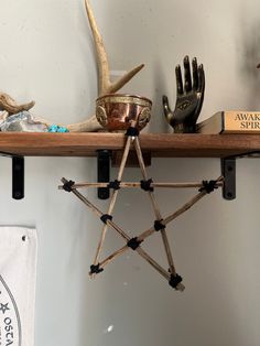 a wooden shelf topped with antlers and other decorative items on top of each other