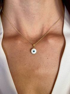 This 14k gold evil eye pendant offers a minimalist yet powerful symbol of protection and good luck. Its tiny design adds a subtle touch of spirituality to any outfit. As a graduation gift for her, it symbolizes not only well wishes for success but also protection and guidance as she embarks on new journeys. This spiritual symbol jewelry serves as a meaningful and thoughtful token of support and encouragement during this important milestone in her life. * DETAILS * * Material: 14K Solid Yellow/Wh Yellow Gold Evil Eye Jewelry For Good Luck, 14k Yellow Gold Evil Eye Charm Necklace, Minimalist Good Luck Pendant Necklaces, Minimalist Good Luck Necklace With Round Pendant, White 14k Gold Charm Necklace With Delicate Chain, 14k Gold Evil Eye Amulet Jewelry, Evil Eye Round Pendant Jewelry For Everyday, Gold Plated Evil Eye Round Pendant Jewelry, Everyday Evil Eye Round Pendant Jewelry