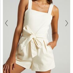 Beige Romper Shaped With Slender Shoulder Straps And A Square Neckline With A Fixed Wrap Tie At The Waist. Zipper Back With Side Pockets. Tie Belt Is Removable. 65% Cotton 30% Polyester. Brand New, Tags Are No Longer Attached But Item Was Never Worn! Chic Cotton Jumpsuits And Rompers With Tie Straps, Beige Cotton Jumpsuits And Rompers For Summer, Chic Cream Jumpsuits And Rompers For Vacation, Elegant Cotton Jumpsuits And Rompers For Summer, Cream Sleeveless Jumpsuit For Day Out, Sleeveless Cream Jumpsuit For Day Out, Chic Beige Cotton Jumpsuits And Rompers, Chic Beige Cotton Jumpsuit, Summer Cream Overall Jumpsuits And Rompers