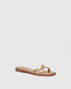 Toby is the day-to-night flat sandal you’ll be wearing on repeat. Crafted from supremely soft dark gold metallic leather, this easy slip on sandal is designed with interlocked asymmetrical straps, a soft square toe shape with an extended smooth leather welt, a slightly inset footbed, and a tan leather 15mm heel for a slight lift. This chic silhouette pairs effortlessly with cropped denim during the day or a flirty dress at night. | Toby Sandal - Dark Gold Metallic Leather | Size 5.5 Premium Denim Jeans, Men Store, Flirty Dresses, Denim Shoes, Dark Gold, On Repeat, Cropped Denim, Metallic Leather, Flat Sandals