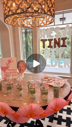 the table is set up with glasses and flowers on it for a party or celebration