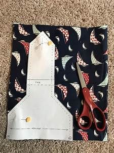 a pair of scissors sitting on top of a piece of fabric next to some scissors