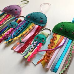 a group of different colored hair clips on a table with one being a keychain and the other is an octopus