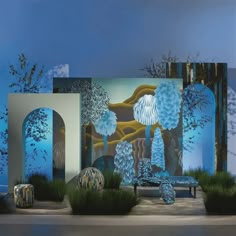 an artistic scene is shown with blue and white decorations in the foreground, trees on the far side