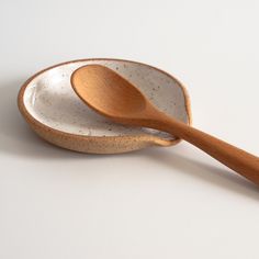 two wooden spoons sitting next to each other