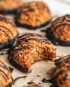 chocolate covered doughnuts are sitting on a baking sheet