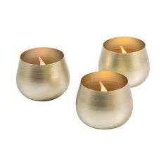 three gold tealight candles sitting next to each other