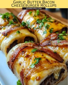 bacon wrapped cheeseburger rolls on a white plate with text overlay that reads garlic butter bacon cheeseburger rolls