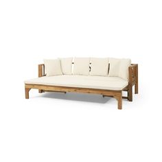 a wooden couch with four pillows on it's back and two arms, in front of a white background