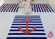 an anchor table runner with mason jars and striped paper straws on the table top