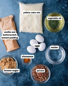 ingredients to make the best glub cake recipe on a blue surface with flour, eggs