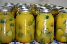 several jars filled with pickles sitting on top of a table