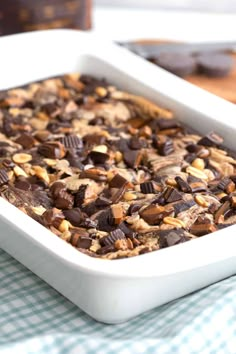 a white dish filled with chocolate and nuts