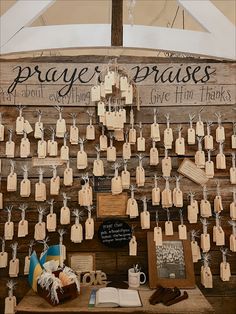 a wooden table topped with lots of cards and tags hanging from it's sides