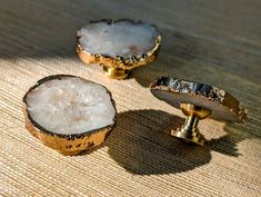 two pieces of wood sitting on top of a table next to each other with white crystals in them