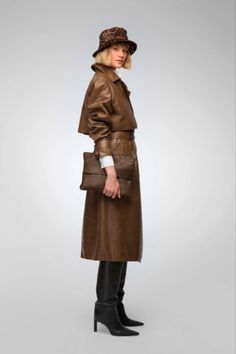 Women's Trench Leather Coat In Dark Brown With Belted Waist Embrace timeless elegance with this women's trench leather coat in dark brown. Crafted from genuine sheepskin leather with a semi-aniline finish, this coat features a sophisticated wrap-belted closure and a turn-down collar. It's designed with open hem cuffs, one inside pocket, and two side pockets for practicality. The belted waist accentuates your silhouette, making it an exquisite choice for both style and warmth in cooler weather. Outer Shell: Genuine Leather Leather Type: Sheepskin Leather Finish: Semi-aniline Feature: Belted Waist Closure Style: Wrap Belted Collar Style: Turn Down Cuffs Style: Open Hem Inside Pockets: One Outside Pockets: Two Side Pocket Color: Dark Brown Luxury Brown Leather Jacket For Fall, Elegant Brown Leather Jacket For Winter, Luxury Brown Belted Outerwear, Brown Outerwear With Leather Lining For Work, Brown Leather Lined Outerwear For Work, Brown Leather-lined Outerwear For Work, Belted Brown Outerwear For Business, Luxury Brown Leather Jacket For Work, Elegant Brown Leather Jacket For Fall