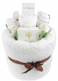 a white gift basket filled with lots of different types of baby items in it's pouch