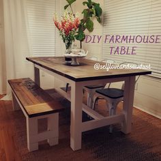 a table with two benches in front of it and a vase on the table next to it