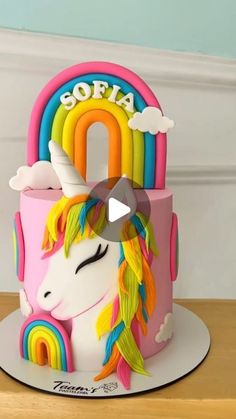 a birthday cake with a rainbow unicorn on top