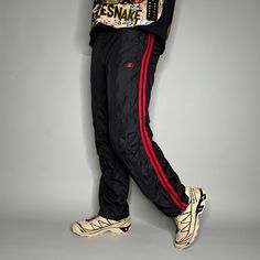 "Vintage Starter Track Pants Jet Black Polyester Crimson Red Lined has Ankle Zippers to Flare Y2K Skate / Streetwear Great Condition: 9/10 Men's Size: X-Small (no tag) My Hands in Pockets = It has Pockets No Hands in Pockets = Does Not Have Pockets Drawstring Will be Visible in Forward Pic, if not Visible it Does Not Have a Drawstring About me: I am 6' 0\" for reference I generally wear a Large (32\" inseam) I Model XS to 2XL sweatpants, I find that you can often size up or down with 95% of sweatpants and they fit the same" Red Pants For Winter Streetwear, Red Winter Streetwear Pants, Casual Winter Pants With Zip Fly, Red Nylon Sportswear Bottoms, Sporty Red Nylon Pants, Red Nylon Sporty Pants, Winter Sportswear Red Bottoms, Red Sports Pants For Winter, Red Winter Sports Pants