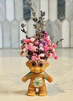 a small vase filled with flowers on top of a table