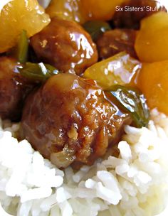 meatballs and rice with oranges on a plate