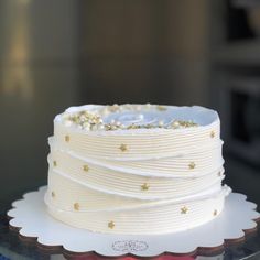 a white cake with gold stars on it