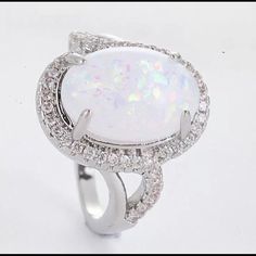 Beautiful Simulated Fire Opal Moonstone Surrounded By Pave Zirconia Set In A Sterling Silver Setting Stamped 925. Comes In A Tiffany Blue Gift Box. Opal Moonstone, Moonstone Ring Sterling Silver, Blue Gift, Tiffany Blue, Womens Jewelry Rings, Fire Opal, Sterling Silver Ring, Moonstone, Silver Ring