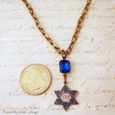 "Star of David Necklace with Vintage Sapphire Rhinestone. Hand Painted Silver and Blue Assemblage Jewelry. Jewish / Judaica Jewelry. This lovely necklace features: * a detailed brass Star of David which is made from vintage molds. It hand painted silver and blue and lacquered to protect the patina. * Genuine Vintage Czech Glass Sapphire Rhinestone (from the 1970s or earlier...40+ years old!) These vintage Czech rhinestones are handset in our studio in professionally plated settings. Czechoslovak Jewish Jewelry Necklaces, Blue And Silver Jewelry, Vintage Molds, Rams Horn, Patina Jewelry, Star Of David Necklace, Judaica Jewelry, Jewish Women, Jewish Jewelry