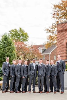 a group of men in suits standing next to each other