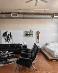 a living room filled with furniture and a flat screen tv mounted to the side of a wall