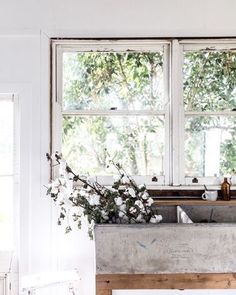 a kitchen sink sitting under a window next to a counter