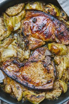 a pan filled with meat and vegetables on top of a table