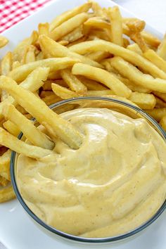 a plate with french fries and dip on it