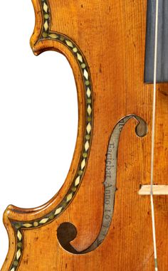 an old violin with some strings attached to it's back and side ends,