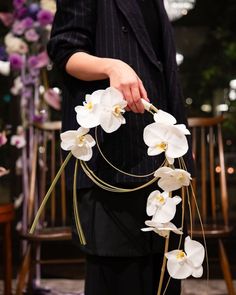 a person holding flowers in their hands