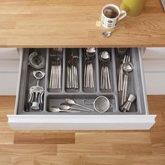 a drawer with utensils and spoons in it