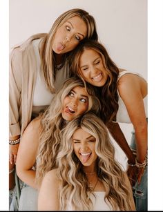 four women are posing for a photo together